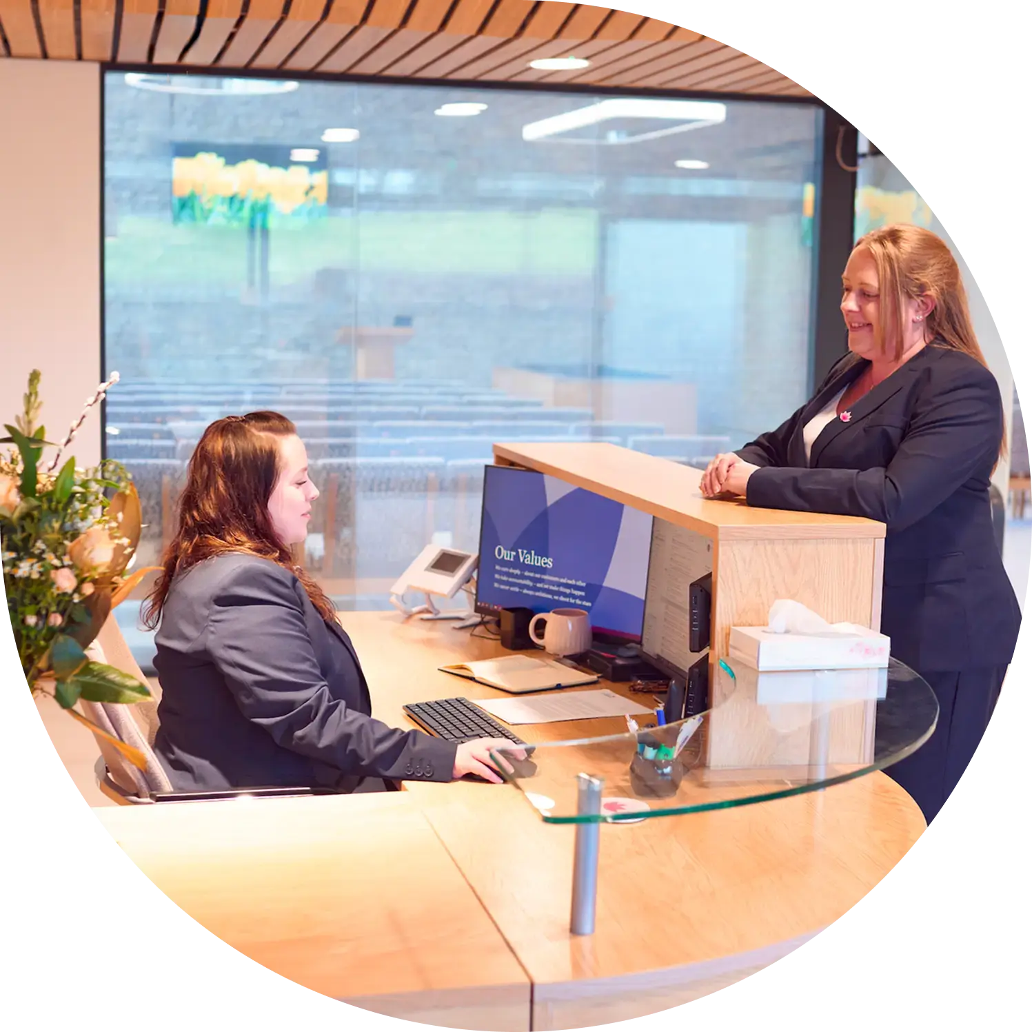 Two smiling women at reception